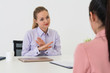 © InfiniteFlow - Two young business women in meeting at office table for job application and business agreement. Recruitment and human resources concept.