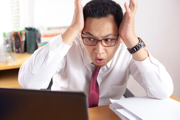 Asian Businessman Working on Laptop Shocked Stunned gesture