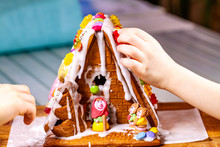 Familiy Building A Sweet Ginger Bread House
