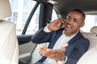 © Viktoriia - Young businessman sitting on back seat in car talking on smartphone shouting at driver irritated