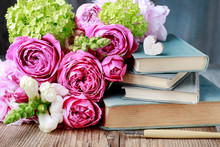 Old Books And Bouquet Of Flowers.