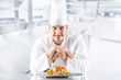 © weyo - Chef in restaurant kitchen with plate from italian meal spaghetti bolognese
