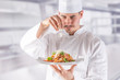 © weyo - Chef in restaurant kitchen prepares and decorates meal with hands.Cook preparing spaghetti bolognese