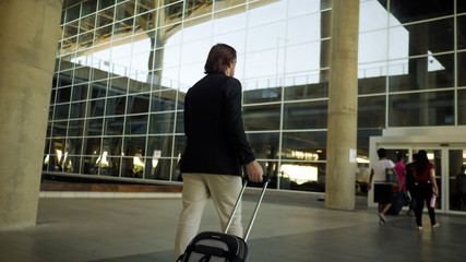 Wall Mural - Man walking by the airport, boarding and landing