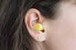© Tunatura - Woman's ear with an ear plug, noice reduce, noice pollution