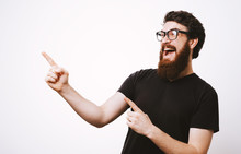 Photo Of Handsome Fancy Man Wearing Black T-shirt Having Fun And Pointing Fingers Away Meaning Hey You Isolated Over White Background