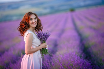 Wall Mural - beautiful bride in luxurious wedding dress in purple lavender flowers. Fashion romantic stylish woman with violet bouquet. Alluring slim girl in sunset over lavenda waiting for groom - Provence France