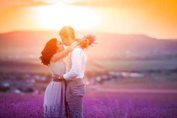 Wall Mural - Bride and groom couple, wedding day in summer. A moment of happiness and love in a lavender field. 