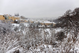 Fototapeta Do pokoju - Snowy foggy Prague City with gothic Castle from Hill Petrin, Czech republic
