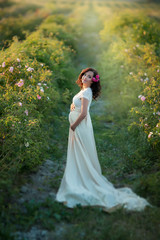 Wall Mural - Outdoor natural portrait of beautiful pregnant woman in white dress