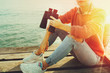 © tinyakov - Young Girl Sits On A Pier With Binoculars In Hand And Enjoys The View Of Nature