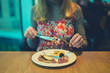 © LoloStock - Young woman having breakfast in hotel