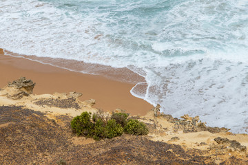 Wave water below a rock cliff.