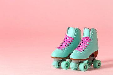 Wall Mural - pair of vintage roller skates on color background. space for text