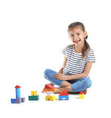 Sticker - Cute child playing with colorful blocks on white background