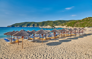 Poster - Beach with loungers and umbrellas in Greece