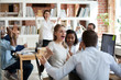 © fizkes - Excited diverse business team employees screaming celebrating good news success