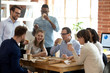 © fizkes - Multi-ethnic employees group enjoy takeaway food friendly conversation in office