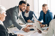 © alfa27 - Emotionally excited multiracial businessmen discussing business documents, vivid real emotions and people in common everyday business routine situations