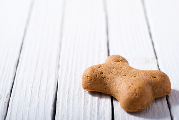 Poster - bone shape dog biscuit on white wood background