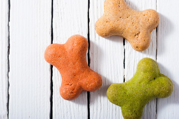 Poster - bone shape dog biscuits on white wood background