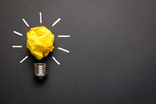 Great Idea Concept With Crumpled Yellow Paper Light Bulb Isolated On Dark Background