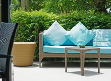 Blue Cushion Wicker Sofa Bench In Small Modern Garden Outdoors.