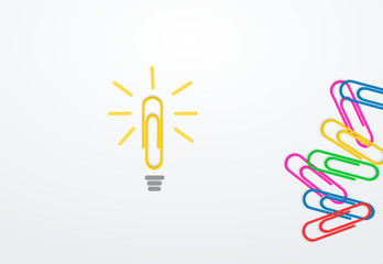 Wall Mural - yellow paperclip on paper next to paperclips as a symbol of a light bulb. business idea concept