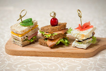 Buffet Sandwiches With Fish, Cheese And Cucumbers On The Kitchen Board. Restaurant Menu.
