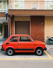  Italian Retro Car On The Road In Cattolica. Small Vintage Red Car.