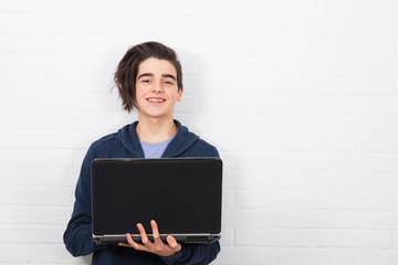 Poster - young man with computer isolated in white wall