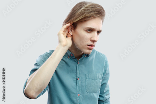 Portrait Of Serious Handsome Long Haired Blonde Young Man In Blue