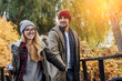 © klepach - Two young travel couple walking on bridge