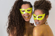 © Nexa - Two beautiful young women with their bodies painted in gold. Young African-American women dressed up as masks and with their bodies painted for the carnival.
