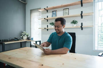portrait of young businessman get message a good news with smartphone about development of her business