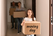 © Pixel-Shot - Little girl and her parents with cardboard boxes indoors. Moving into new apartment