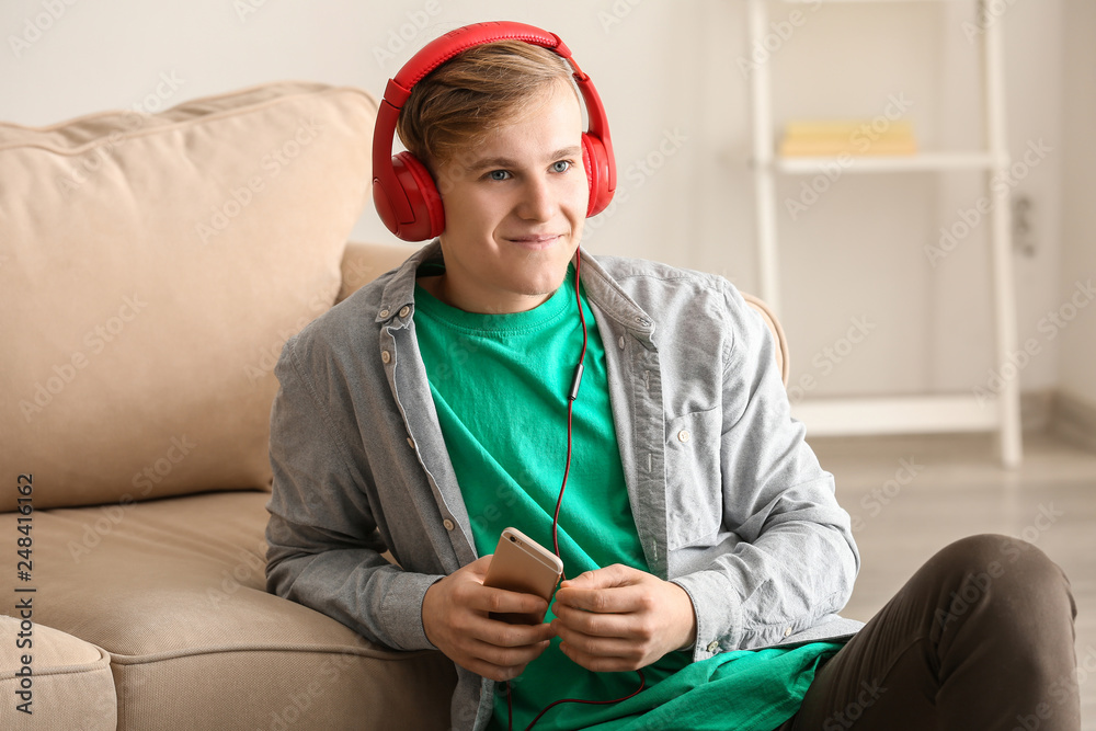 Handsome young man listening to music at home