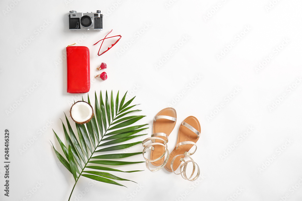 Flat lay composition with female items and photo camera on white background