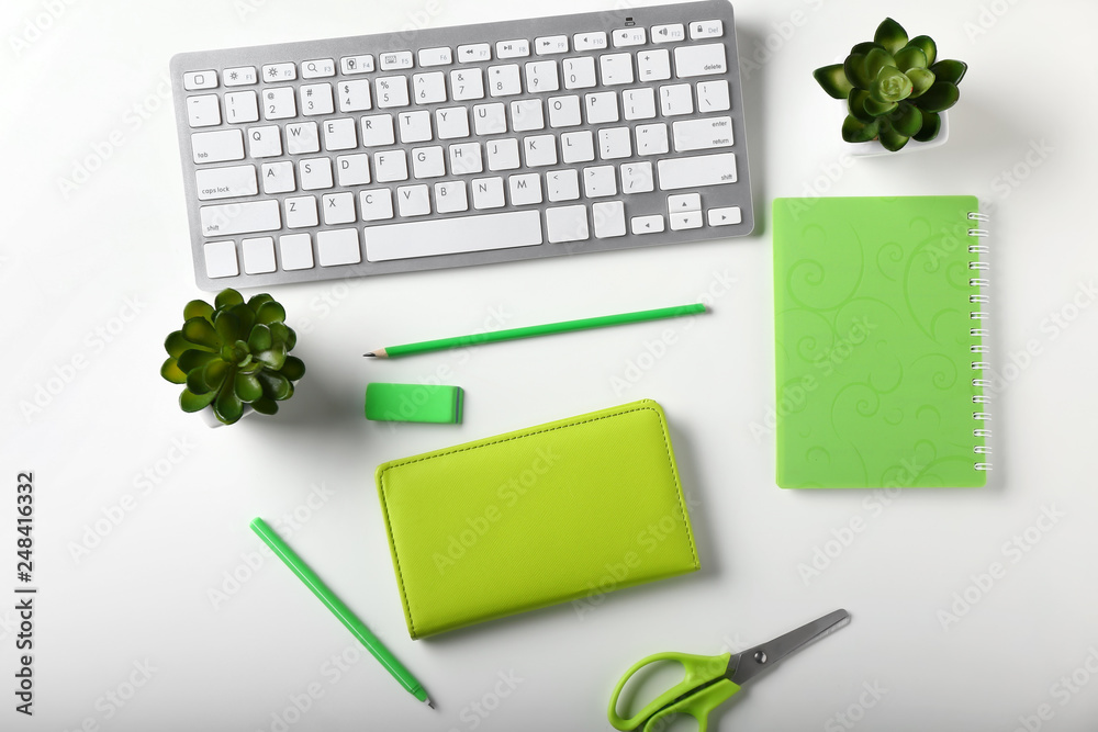 Stylish workplace with computer keyboard and stationery on white background