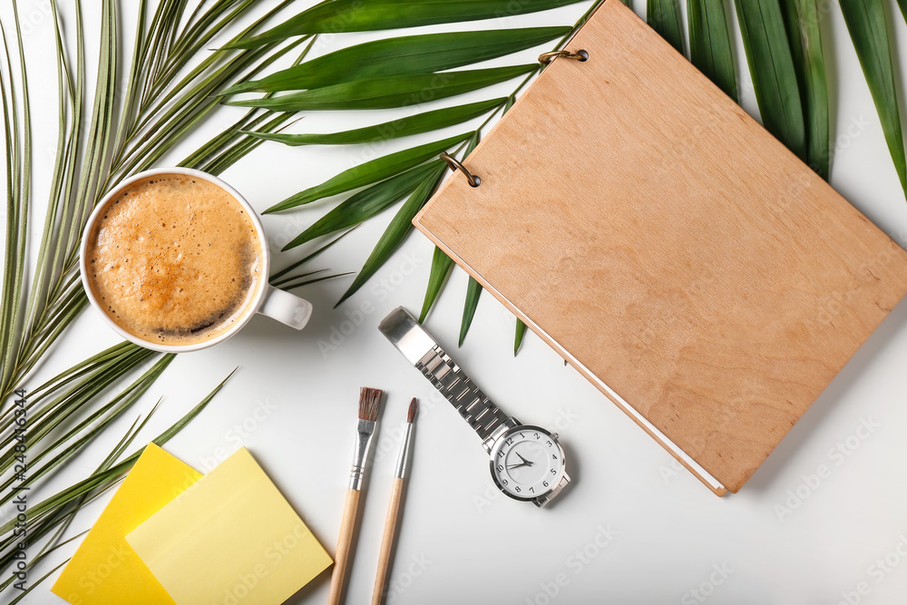 Composition with cup of coffee, stationery and watch on white background
