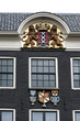 Coat of arms of Amsterdam on the facade of the house in Amsterdam, Netherlands