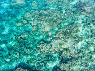 Wall Mural - Aerial top down people snorkeling on coral reef tropical caribbean sea, turquoise blue water. Indonesia Wakatobi archipelago, marine national park, tourist diving travel destination