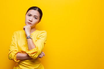 Wall Mural - Woman feel confused isolated over yellow background