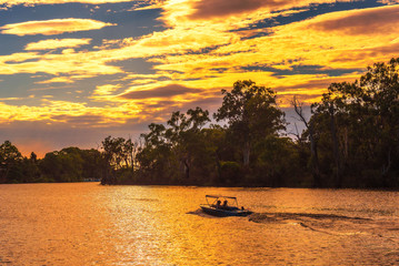 Wall Mural - Sunset over Murray river with a boat in Mildura, Australia