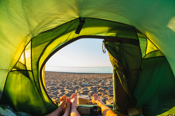 feet out of a tent overlooking the seashore