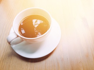 cup of coffee on wooden table