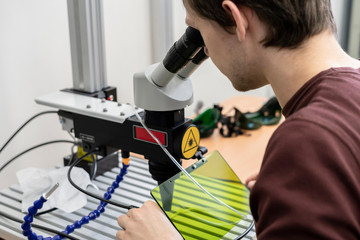 male scientist do research in laboratory with microscope b