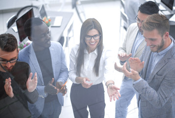 Wall Mural - close up.a group of successful young businessmen applauds