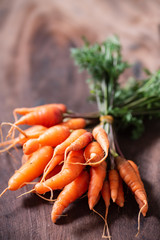 Fresh carrots on wooden background, organic vegetable