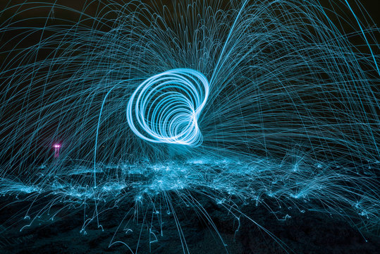 Amazing Fire dancing steel wool and lamp in the night.